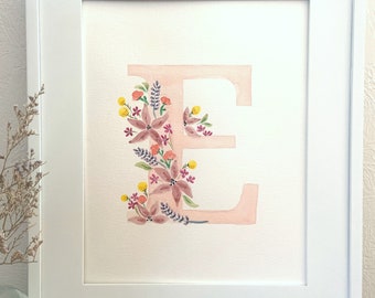May include: A watercolor painting of the letter E with pink and purple flowers and yellow centers. The letter is pink and the background is white.