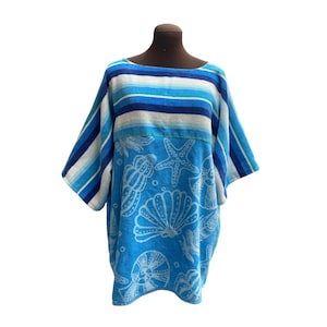 May include: A short-sleeved cover-up featuring a horizontal striped pattern in shades of blue, white, and turquoise on the upper section, while the lower portion displays a white seashell and starfish print on a bright blue background.