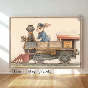 May include: Watercolor print of a vintage train with a rabbit conductor wearing a blue uniform and cap. The train is brown, black, and red, with the words "Carts Chat" on the side. The artwork is framed.