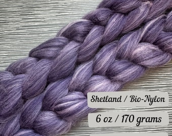 May include: Purple and white Shetland wool roving with bio-nylon, 6 ounces or 170 grams. Shetland / Bio-Nylon 6 oz / 170 grams Ships next business day