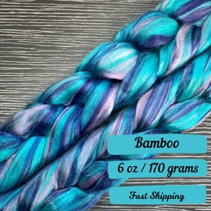 May include: A braid of teal, purple, and white bamboo fiber yarn. The yarn is 6 ounces or 170 grams. The text "Bamboo", "6 oz / 170 grams", and "Fast Shipping" is on the image.
