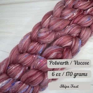 May include: Braided skein of Polwarth/Viscose yarn in shades of burgundy, with flecks of blue and white. The yarn weighs 6 oz (170 grams).