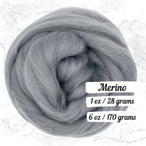 May include: A ball of gray Merino wool roving. The text on the image reads "Merino", "1 oz / 28 grams", and "6 oz / 170 grams". The wool is soft and fluffy, ideal for various fiber crafts like felting and spinning.