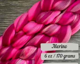 May include: Pink and white merino wool roving, braided in a thick rope shape. 6 oz / 170 grams.