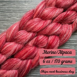 May include: A braid of red and white merino and alpaca fiber, 6 ounces or 170 grams. Ships next business day.