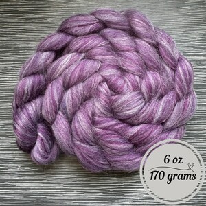 May include: A purple and white wool roving, 6 ounces or 170 grams.