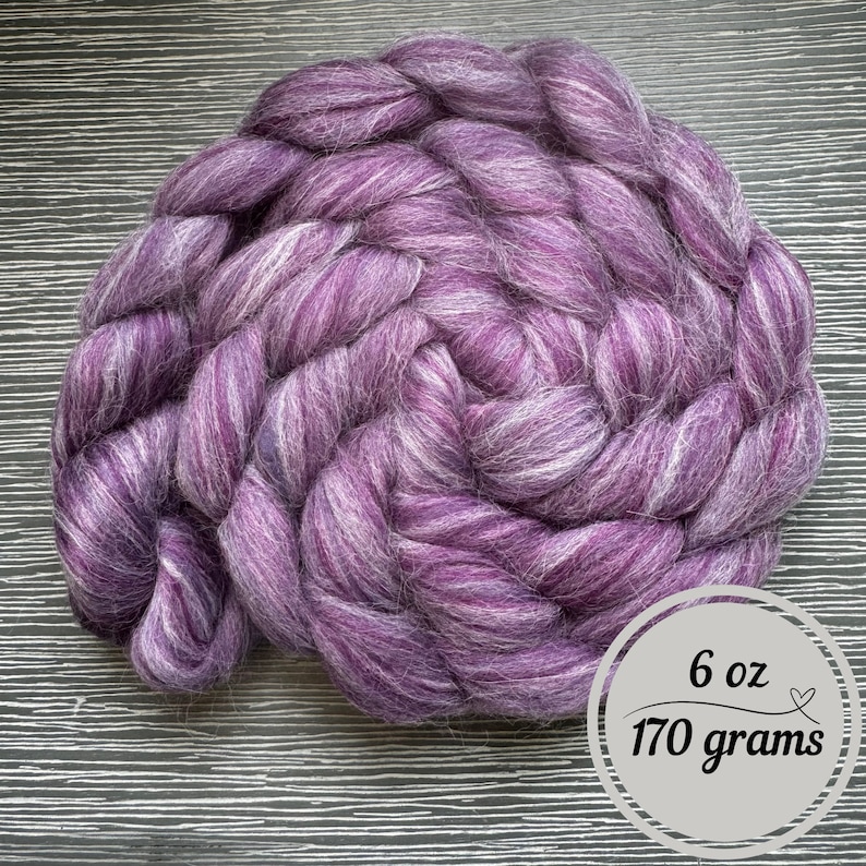 May include: A purple and white wool roving, 6 ounces or 170 grams.