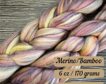 May include: A braid of purple, pink, yellow, and white merino and bamboo fiber yarn. Merino/Bamboo 6 oz / 170 grams Fast Shipping