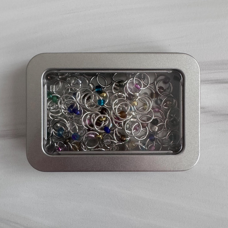 May include: A white ceramic mug with a black handle and the text "But First, Coffee" in a bold, black font. The mug is set against a neutral background, highlighting its simple design.