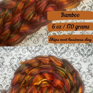 May include: A 6 ounce (170 gram) skein of bamboo yarn in a mix of red, orange, yellow, and green colours. The yarn is arranged in a loose ball shape.