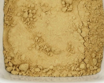May include: A white ceramic bowl filled with light brown ginger powder.