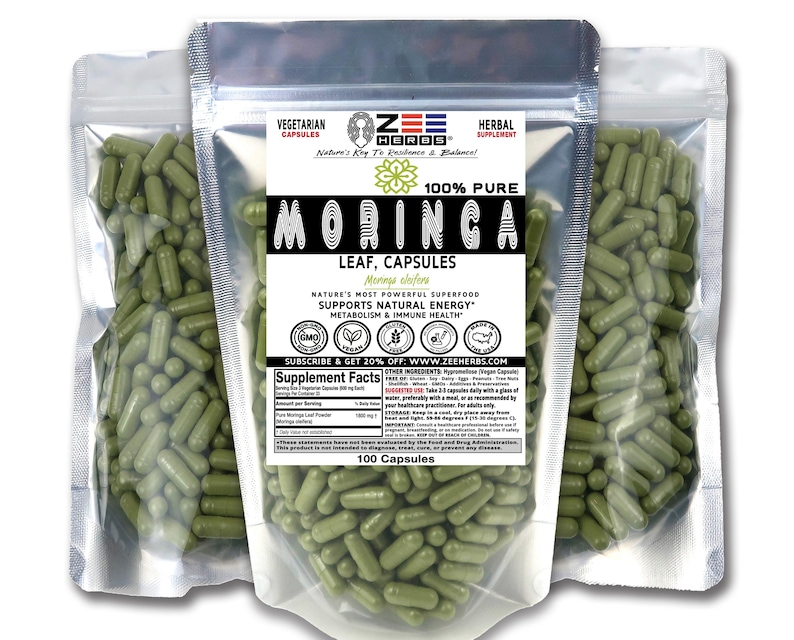 May include: Three silver foil pouches filled with green Moringa leaf capsules. The front label features the Zee Herbs logo, the text 100% Pure Moringa Leaf Capsules, and a supplement facts table. Each pouch contains 100 vegetarian capsules.