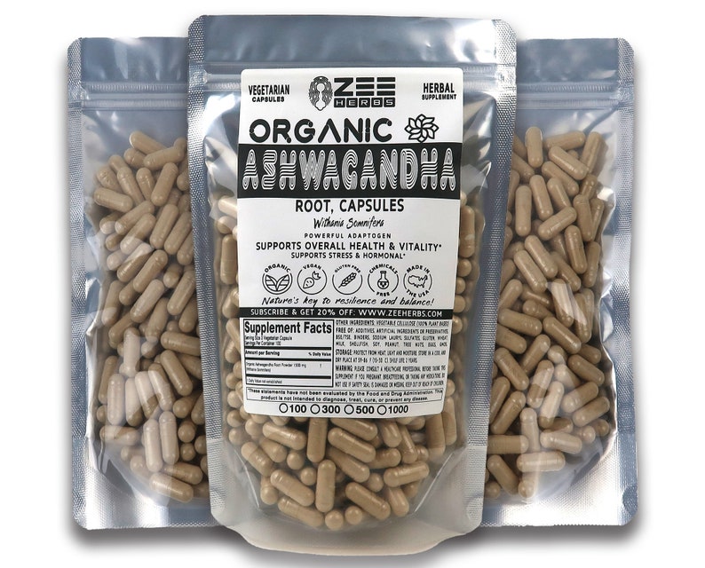 May include: Three silver pouches containing brown capsules labeled "Organic Ashwagandha Root, Capsules" with the brand name "Zee Herbs" and the text "Nature's key to resilience and balance!"  The pouches are labeled with the text "Vegetarian Capsules" and "Herbal Supplement".