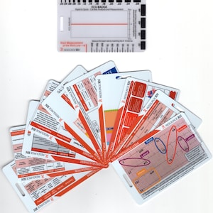 May include: A set of 10 red and white laminated cards with the text "RESOURCE RN" on each card. The cards are fanned out and show different ECG diagrams and information about the heart. The cards are designed to help nurses and other healthcare professionals understand and interpret ECG readings.