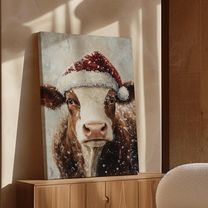 Rustic Holiday Cow Wall Art - Santa Hat Farmhouse Christmas Decor - Festive Cow Portrait in Snowflakes - Cozy Winter Farm Animal Canvas