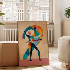 May include: A framed abstract art print featuring a colorful geometric design of two figures. The artwork uses a palette of teal, orange, pink, and blue against a beige background. The print is displayed in a light-colored wooden frame.