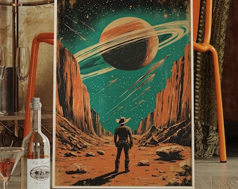 May include: A framed art print featuring a retro-style illustration of a person in a cowboy hat standing in a desert landscape, gazing at a planet with rings. The artwork has a vintage aesthetic with a color palette of orange, teal, and brown.