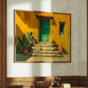May include: A framed painting depicts a yellow building with a green door and steps. Cacti and potted plants are in front of the building. The painting is in a room with wooden furniture, including a dresser, chair, and table. Sunlight streams through a window.