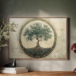 May include: A framed print of a stylized tree with green leaves and brown roots, surrounded by a gold and green circular design. The print is hanging on a green wall above a wooden shelf with a lamp and books.