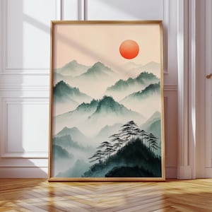 This Japanese sumi-e mountain print features a misty landscape with a bold red sun, evoking serenity and zen aesthetics. Inspired by traditional brush painting, this minimalist Asian wall art is perfect for meditation spaces, wabi-sabi interiors, and tranquil home decor.