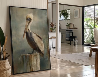 Könnte beinhalten: Gerahmter Leinwandkunstdruck mit einem Pelikan auf einem Holzpfahl. Der Pelikan hat braune und weiße Federn und einen langen Schnabel. Der Hintergrund ist ein gedämpftes Blau und Grau, was dem Kunstwerk einen Vintage-Look verleiht. Der Rahmen ist schwarz.