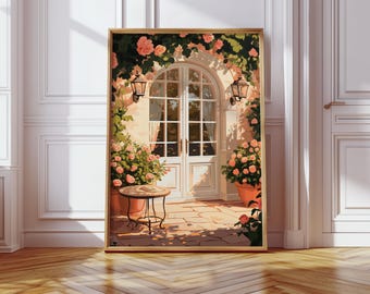 Può includere: Una stampa artistica incorniciata raffigura una scena di cortile soleggiato. Una porta ad arco bianca è incorniciata da rose rampicanti e affiancata da piante in vaso. Un tavolino si trova su un patio in mattoni e due lanterne sono appese al muro. L'opera d'arte è in una cornice dorata.