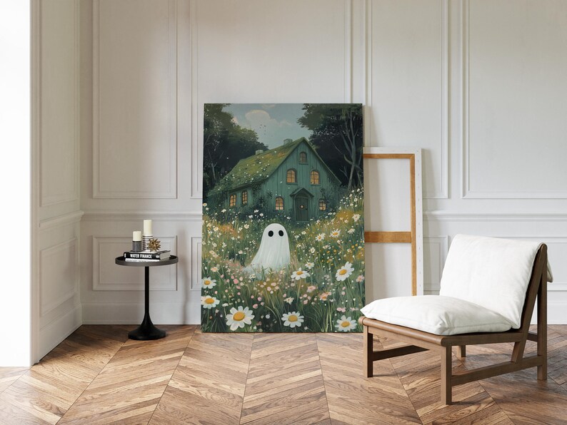 May include: An art print depicting a teal house in a field of daisies, with a ghost. The artwork has a soft, dreamy quality, ideal for adding a touch of fantasy to any room. The print is displayed in a room with a wooden floor.
