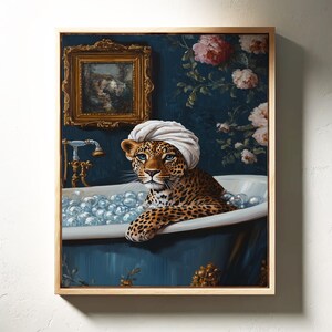 May include: A leopard wearing a white towel on its head is relaxing in a white bathtub filled with bubbles. The bathtub is in a room with blue walls and floral wallpaper. There is a gold framed picture on the wall behind the leopard.