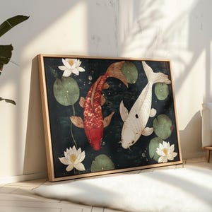 May include: Framed artwork featuring two koi fish in a pond with lily pads and lotus flowers. One koi is red, the other is white. The background is dark green, and the frame is light brown.
