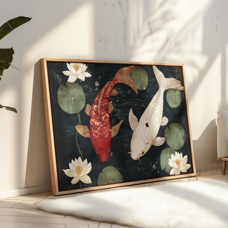 May include: Framed artwork featuring two koi fish in a pond with lily pads and lotus flowers. One koi is red, the other is white. The background is dark green, and the frame is light brown.