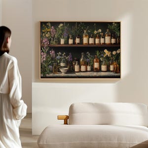 May include: A framed print of a vintage apothecary shelf with a variety of glass bottles filled with liquids and herbs. The shelf is surrounded by a lush green background with flowers and leaves.