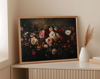 May include: A framed floral print featuring a dark background with a variety of flowers in shades of red, pink, white, and cream. The artwork is displayed on a light-colored cabinet, with a white vase and decorative plant.