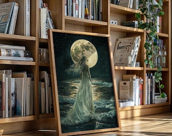 May include: A framed art print depicts a woman in a flowing white gown standing before a large, luminous full moon over a dark ocean. The artwork is set in a wooden frame and leans against a bookshelf filled with books.