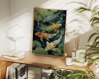 May include: A framed art print featuring a watercolor painting of koi fish swimming among lily pads. The fish have orange, white, and black markings. The artwork is displayed on a wooden shelf with books, a lamp, and a small radio.