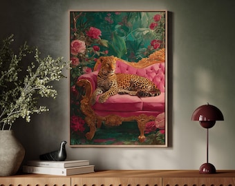 May include: A framed artwork depicts a leopard resting on a pink, ornate sofa. The background features lush greenery and red roses. The artwork is displayed above a wooden cabinet, with a vase of greenery and a burgundy lamp.