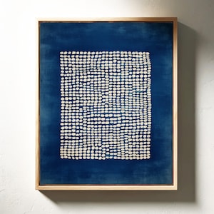 May include: Abstract art print in a natural wood frame. The artwork features a dark blue background with a square of white dots. The dots are arranged in a grid-like pattern. The frame is a light brown color.