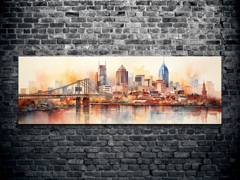 Op de afbeelding: Een aquarel schilderij van een skyline met een brug op de voorgrond. De gebouwen zijn in tinten bruin, oranje en geel, en de lucht is zachtblauw. Het water is diepblauw, en de reflectie van de stad is zichtbaar in het water.