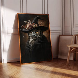 May include: A framed artwork featuring a detailed owl wearing a witch's hat adorned with flowers. The owl is depicted in dark colors, with striking yellow eyes. The artwork is displayed against a neutral background, with a wooden frame.