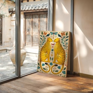 May include: A decorative wooden art piece featuring two yellow cheetahs with black spots facing each other. The artwork is surrounded by floral and botanical elements, including flowers, leaves, and birds. The background is a light beige color.