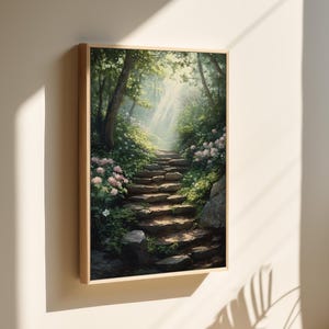 May include: A framed painting of a stone pathway leading up a hill through a lush green forest. The path is lined with white flowers and sunlight streams through the trees.