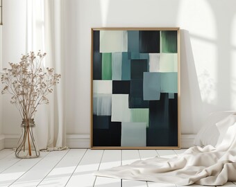 May include: Abstract art print in a wooden frame. The artwork features a geometric design with overlapping squares in shades of green, blue, and white against a black background. The framed art is leaning against a white wall.