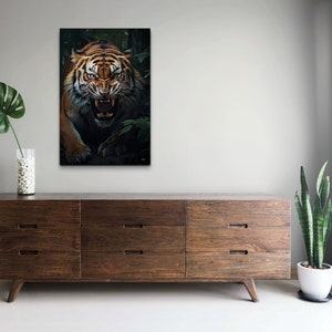 May include: A close-up of a tiger's face with its mouth open, showing its teeth. The tiger is in a dark green jungle setting.