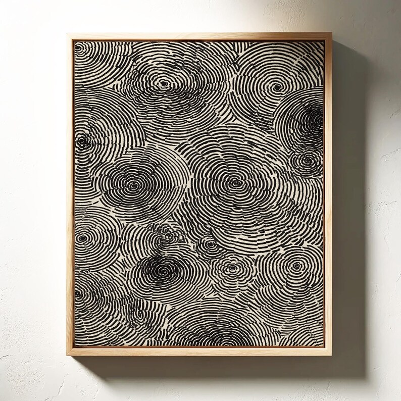 Abstract artwork featuring overlapping circular tree-ring patterns in bold black ink on a white background, creating a modern minimalist organic design.