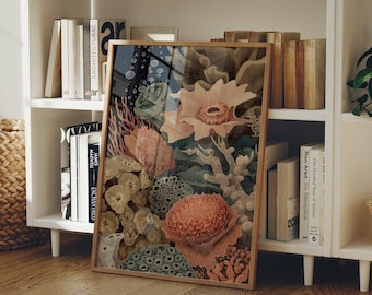 May include: A framed art print depicting coral and marine life in peach, coral, and teal hues. The artwork is displayed on a white bookshelf with books, creating a coastal theme. The frame is a warm, natural wood tone.