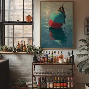 Puede incluir: Una pintura enmarcada de una boya turquesa y roja flotando en agua azul cuelga sobre un carrito de bar. El carrito de bar está lleno de varias botellas de licor y cristalería. Una ventana con marco negro y una pared de ladrillo están en el fondo.