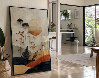 Könnte beinhalten: Ein gerahmter Kunstdruck mit einer Aquarelllandschaft mit einer großen Sonne, Bergen und botanischen Elementen in Orange-, Beige- und Dunkelblautönen. Das Kunstwerk wird in einem modernen Innenraum mit Tageslicht und Holzböden ausgestellt.