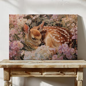 A tender painting of a baby fawn peacefully sleeping among wildflowers. This woodland canvas wall art adds rustic charm and gentle serenity, making it a perfect choice for nurseries, farmhouse spaces, or nature-inspired home decor.