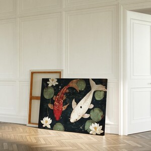 May include: A rectangular canvas print featuring two koi fish, one red and one white, swimming among lily pads and white lotus flowers. The artwork is set against a dark background, with a wooden frame visible behind it.