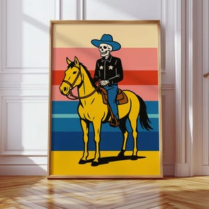 May include: A framed art print featuring a skeleton cowboy riding a yellow horse. The cowboy wears a blue hat and black jacket with star details. The background has horizontal stripes in various colors.