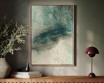 May include: Abstract art print in a wooden frame. The artwork features a blend of teal, white, and brown hues, creating a cloudy or atmospheric effect. The framed art is displayed above a wooden cabinet, with a decorative lamp and vase.
